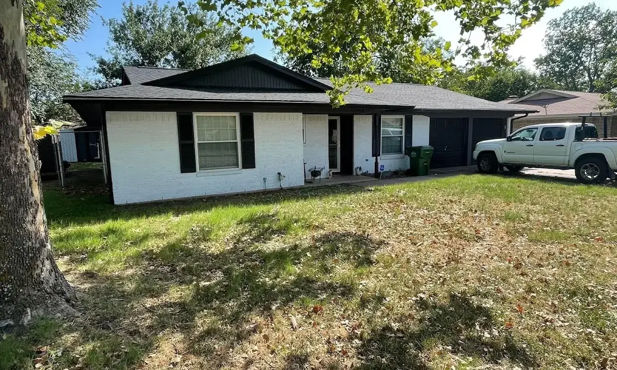 Professional roofing crew working on a residential roof in Ecorse